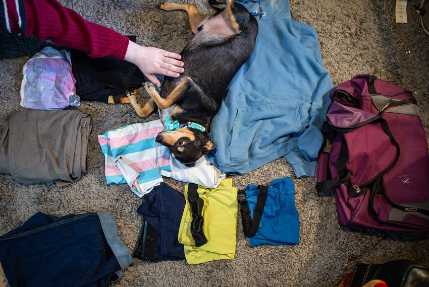 Randell lays out the clothes, including a pair of binders, that he would take if he were forced to flee Texas, in his home in Fort Worth on April 27, 2023.