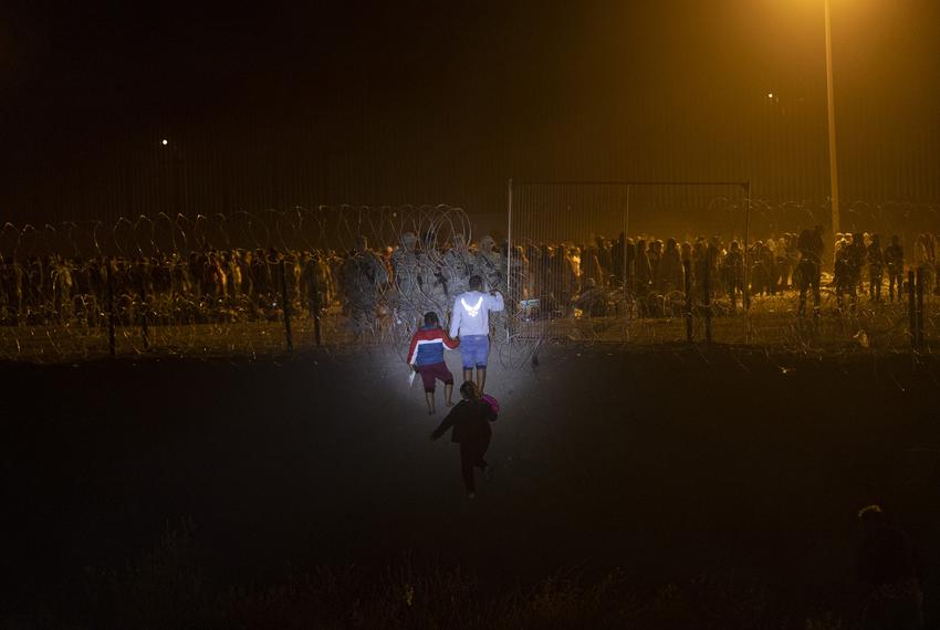 A migrant family from Peru ask Texas National Guard Troops to be let inside a makeshift migrant camp to be processed about two hours after Title-42 ended at 9:59 p.m. local time, Friday, May 12, 2023, in El Paso, Texas. The family was denied entry.