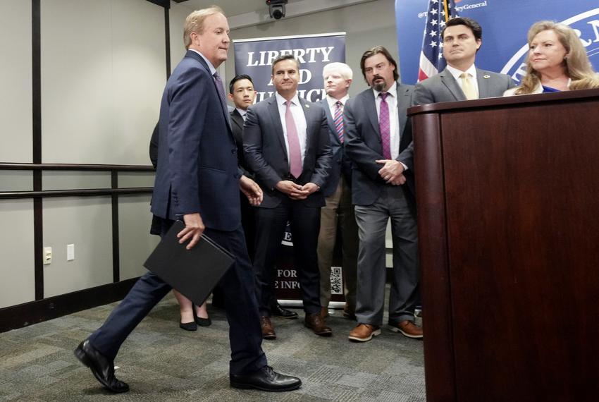 Texas Attorney General Ken Paxton steps to the podium to make a statement to the press on May 26, 2023, a day before a scheduled impeachment vote. Behind him, from left: Tommy Tran, executive assistant; James R. Lloyd, associate deputy attorney general for civil litigation; Austin A. Kinghorn, associate deputy attorney general for legal counsel; Ryan Fisher, director of government relations; Joshua Reno, deputy attorney general for criminal justice; and Suzanna Hupp, special adviser.