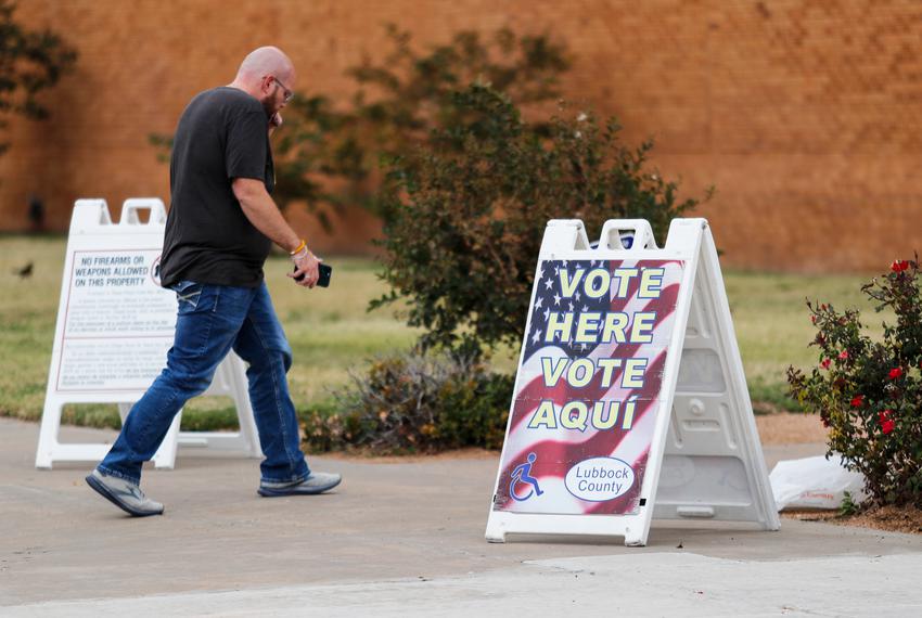 A voter walks past an election sign on his way to vote outside of the Lauro Cavazos Middle School polling station. Lubbock voters chose their voter preferences during the mid-term elections Tuesday, November 8, 2022.