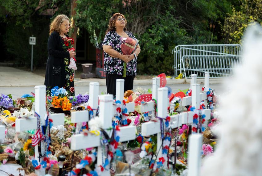 Julie Brown and Irene Marin from San Antonio bring flowers to lay at the memorial of the 21 victims of the school shooting at Robb Elementary in Uvalde, on June 9, 2022.