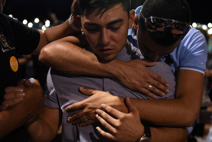 A group of men embrace during a vigil a day after a mass shooting at a Walmart store in El Paso, Texas, U.S. August 4, 2019.  REUTERS/Callaghan O'Hare     TPX IMAGES OF THE DAY - RC1E05433300