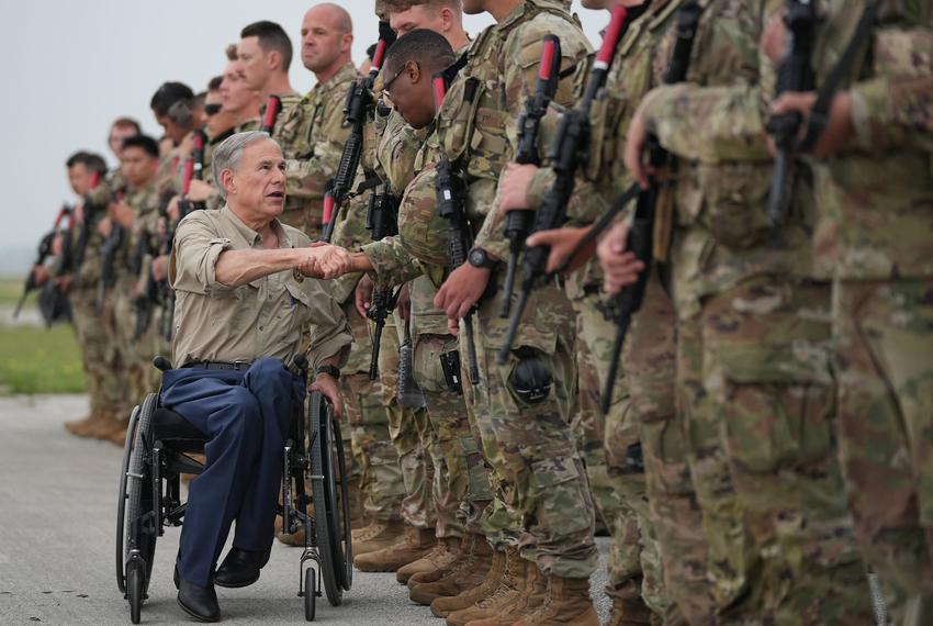 Gov. Greg Abbott greets Texas Army National Guard troops deploying from Austin-Bergstrom International Airport on Monday May 8, 2023, to secure the Texas-Mexico border in anticipation of the end of Title 42 later this week.