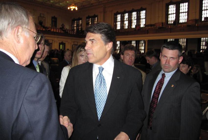 Perry shakes hands after a speech in the Texas House.
