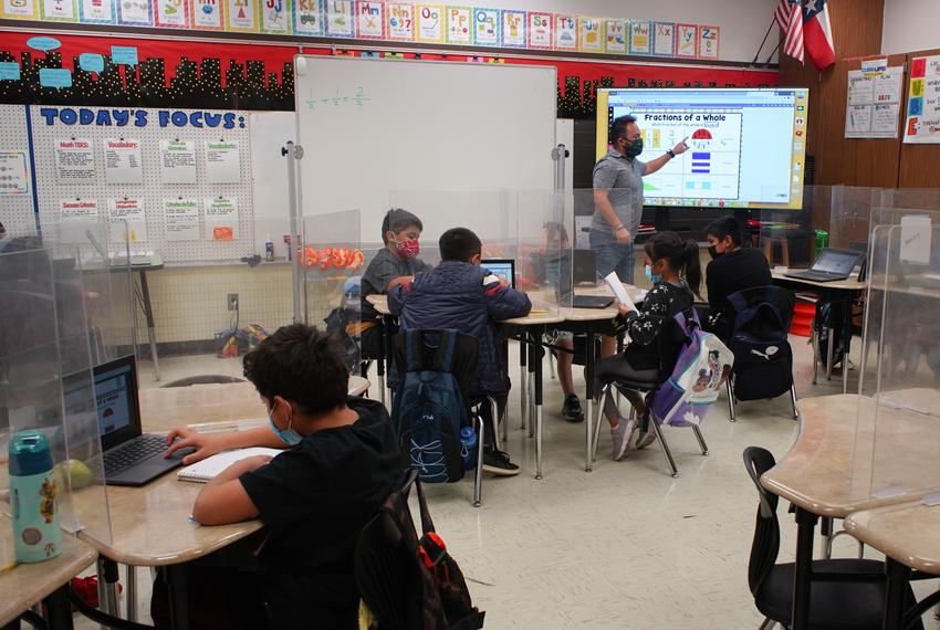 Students sit in Norman Gomez's third grade class at Linder Elementary School in Austin on Jan. 14, 2022. Students and staff wear masks to prevent the spread of COVID-19.
