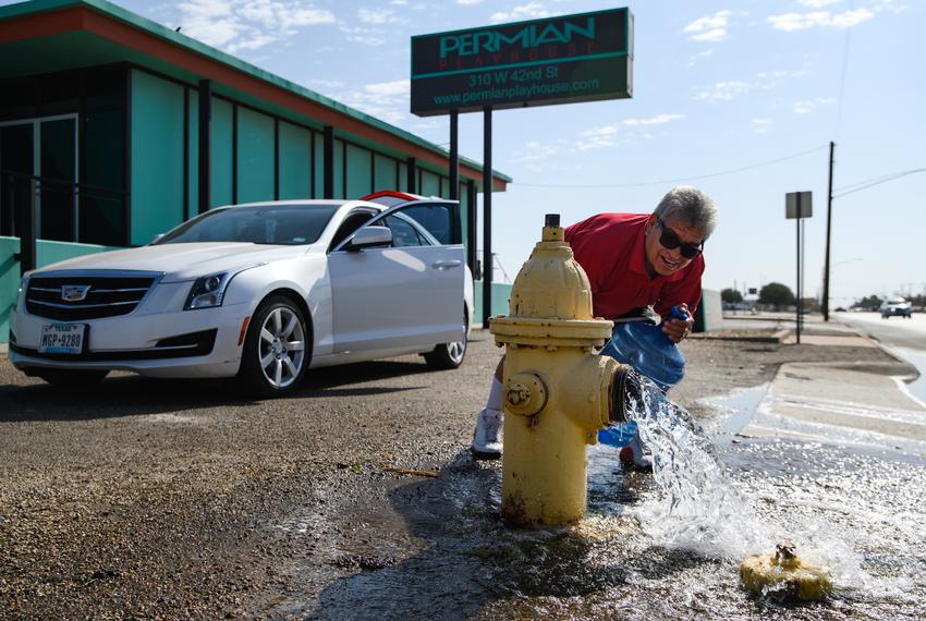 Ector County resident Jose Hernandez fills up jugs of water from a fire hydrant that was opened to reduce pressure on the system as City of Odessa Water Distribution crews work to resolve a water crisis Tuesday, June 14, 2022 in Odessa, Texas. Hernandez stated that he was using the water to operate the toilets in his home. The majority of Ector County was placed on a boil water notice after a water main ruptured sometime between Monday night and early Tuesday morning, leaving residents with little to no running water across the city. City officials state they hope to resolve the issue within 48-72 hours.