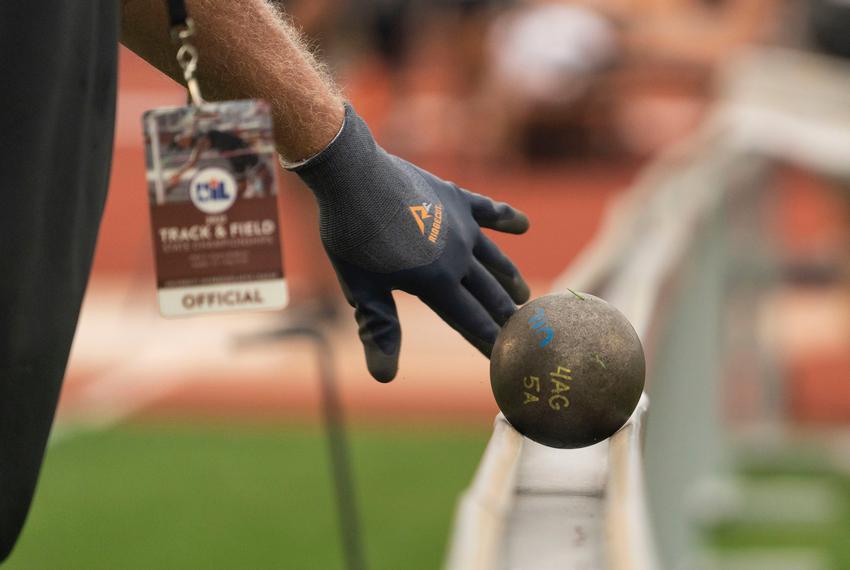 A track and field official places a shootout ball down after its use at the UIL State Track and Field meet, on May 11, 2023, at Mike A. Myers Stadium in Austin.