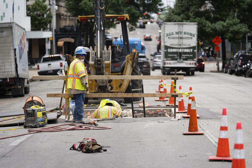 Construction laborers work in Downtown Austin on June 29, 2021.